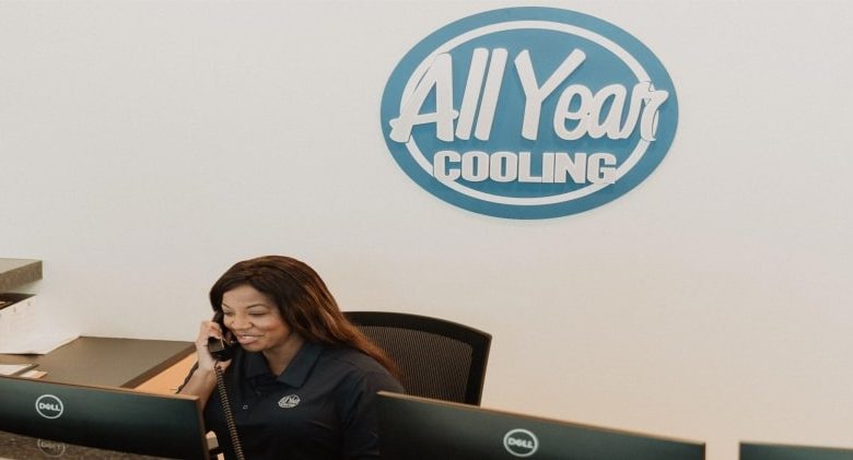 An All Year Cooling employee talking on the phone to someone about their internal financing